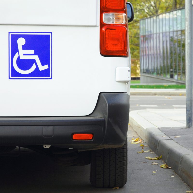 Disability sign on minivan back door, public transport accessibi Disability sign on minivan back door, public transport accessibility